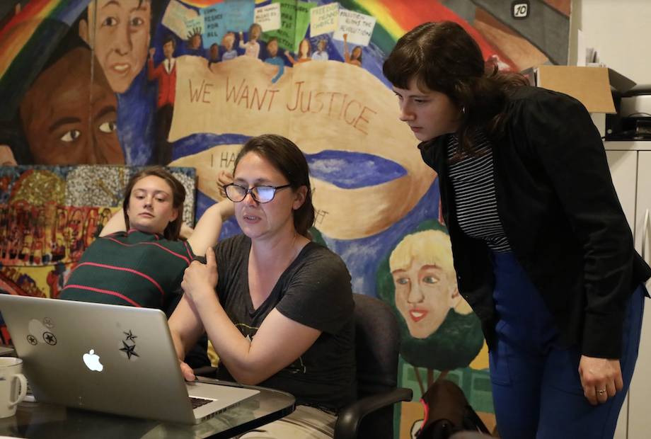 Melanie Hoff looking over the should of a student using a computer